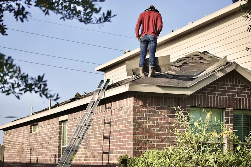 Professional roofer working on a residential roof in Merchantville